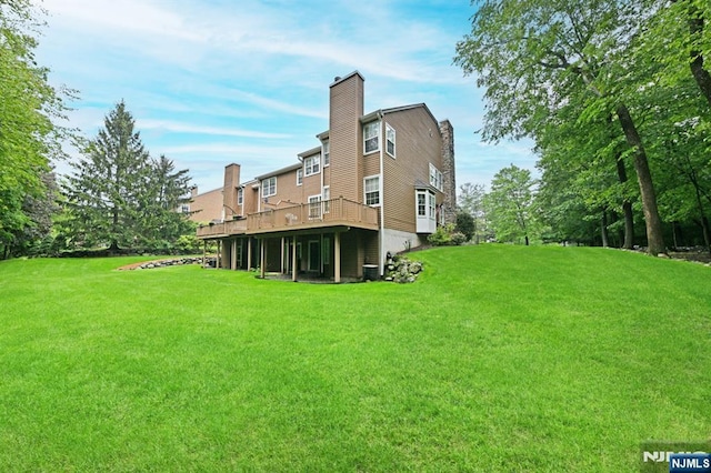 54 Hunter Rd, North Haledon, NJ 07508 - back of property with a yard, a wooden deck, and a chimney
