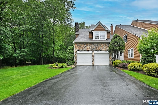 54 Hunter Rd, North Haledon, NJ 07508 - view of front facade with a chimney, stone siding, driveway, a front yard, and an attached garage