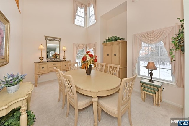 54 Hunter Rd, North Haledon, NJ 07508 - dining space featuring a towering ceiling, light carpet, and baseboards