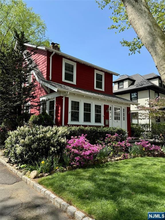 5 Laurel Pl, Glen Ridge, NJ 07028 - view of front of home with a chimney and a front yard