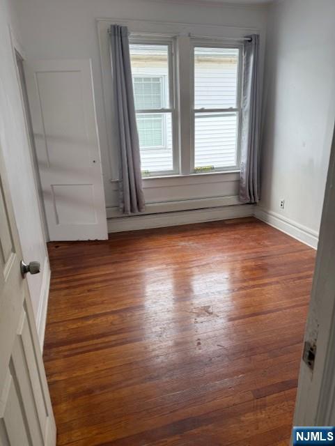 457 7th St, Newark, NJ 07107 - spare room featuring wood finished floors and baseboards