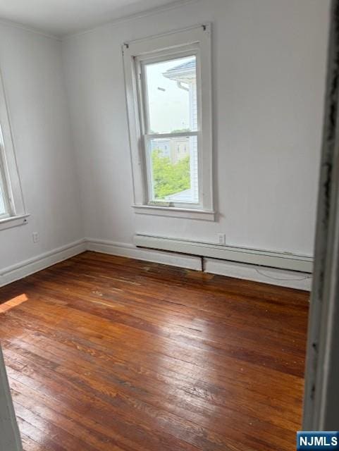 457 7th St, Newark, NJ 07107 - spare room featuring healthy amount of natural light, hardwood / wood-style floors, baseboards, a baseboard heating unit, and crown molding