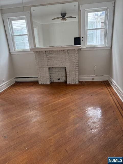 457 7th St, Newark, NJ 07107 - unfurnished living room with wood finished floors, plenty of natural light, a baseboard radiator, and baseboards