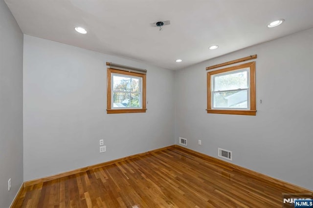 8 Carlisle Ct, Edison, NJ 08817 - empty room featuring plenty of natural light, baseboards, wood finished floors, and recessed lighting