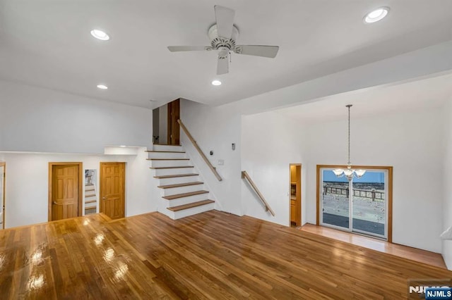 8 Carlisle Ct, Edison, NJ 08817 - unfurnished living room featuring a chandelier, ceiling fan, wood finished floors, stairway, and recessed lighting