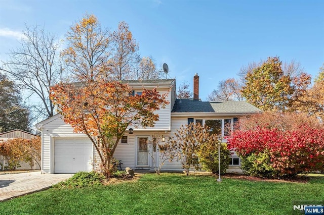 8 Carlisle Ct, Edison, NJ 08817 - view of front facade with a front lawn, driveway, a chimney, and an attached garage