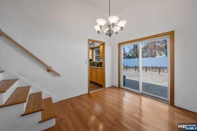 8 Carlisle Ct, Edison, NJ 08817 - unfurnished dining area featuring a chandelier, light wood-type flooring, and stairway