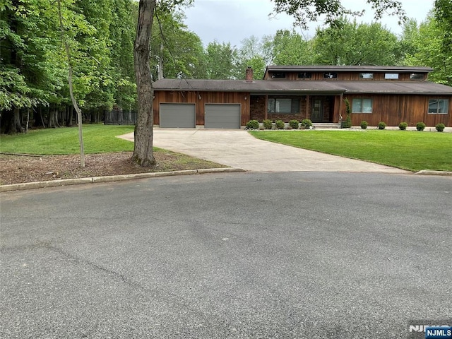 625 Roberge Dr, River Vale, NJ 07675 - view of front of house with an attached garage, driveway, and a chimney