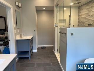 625 Roberge Dr, River Vale, NJ 07675 - full bath featuring a stall shower, two vanities, and baseboards