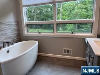625 Roberge Dr, River Vale, NJ 07675 - full bathroom with vanity, a freestanding tub, and baseboards