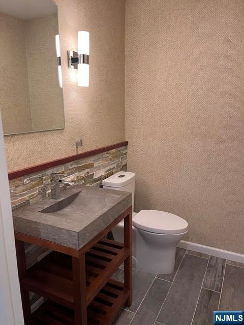 625 Roberge Dr, River Vale, NJ 07675 - bathroom with toilet, vanity, wood finished floors, and backsplash
