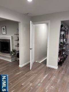 625 Roberge Dr, River Vale, NJ 07675 - unfurnished living room featuring wood finished floors, baseboards, and a fireplace with raised hearth
