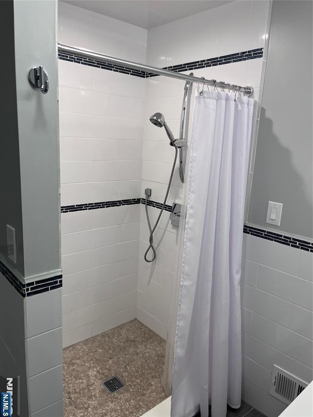 625 Roberge Dr, River Vale, NJ 07675 - bathroom with a tile shower, tile walls, and wainscoting