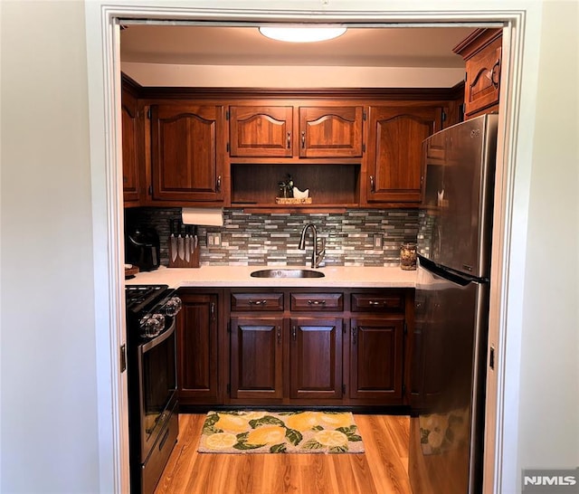 25 Osprey Unit G310, Hackettstown, NJ 07840 - kitchen with freestanding refrigerator, a sink, gas range oven, and light countertops