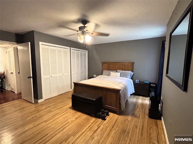 25 Osprey Unit G310, Hackettstown, NJ 07840 - bedroom with light wood-type flooring, multiple closets, baseboards, a ceiling fan, and a textured ceiling