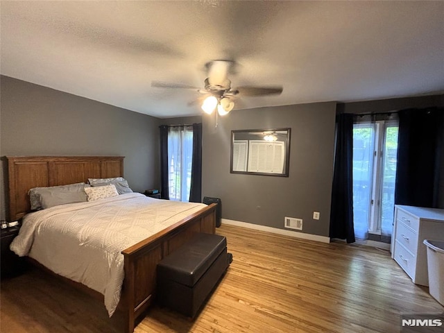 25 Osprey Unit G310, Hackettstown, NJ 07840 - bedroom with light wood-style flooring, baseboards, access to exterior, and ceiling fan