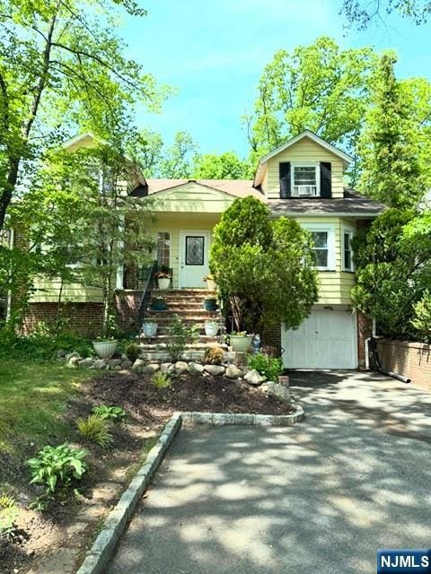14 Crossbrook Rd, Livingston, NJ 07039 - view of front facade featuring asphalt driveway and a garage
