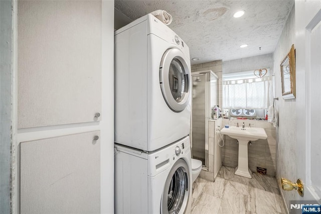 415 Briarwood Ln, Northvale, NJ 07647 - washroom featuring stacked washer / drying machine, light marble finish floors, a textured ceiling, and recessed lighting