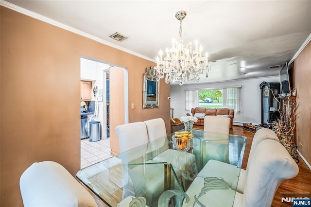 415 Briarwood Ln, Northvale, NJ 07647 - dining space with a chandelier, crown molding, and a baseboard heating unit