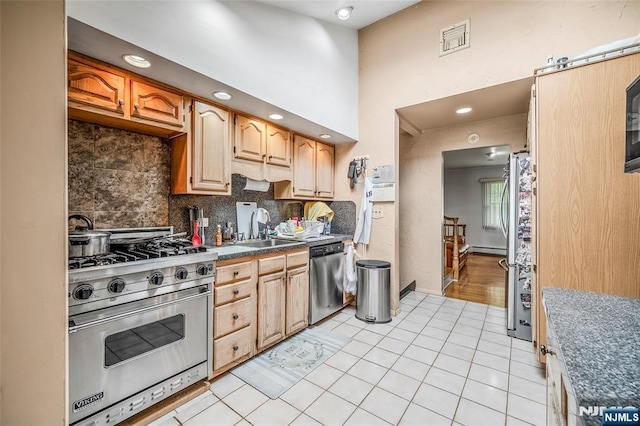 415 Briarwood Ln, Northvale, NJ 07647 - kitchen with appliances with stainless steel finishes, a sink, tasteful backsplash, dark countertops, and light tile patterned flooring