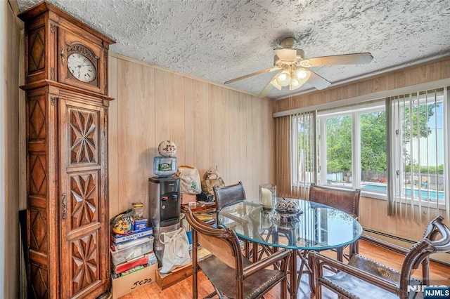 415 Briarwood Ln, Northvale, NJ 07647 - dining area with a ceiling fan, wood finished floors, wood walls, and a textured ceiling