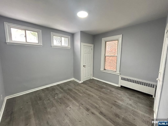207 Tremont Ave, East Orange, NJ 07018 - unfurnished bedroom featuring radiator, wood finished floors, and baseboards