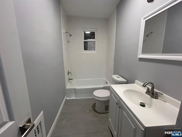 207 Tremont Ave, East Orange, NJ 07018 - bathroom featuring toilet, vanity, tub / shower combination, and baseboards