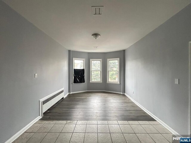 207 Tremont Ave, East Orange, NJ 07018 - unfurnished room featuring radiator, tile patterned flooring, and baseboards