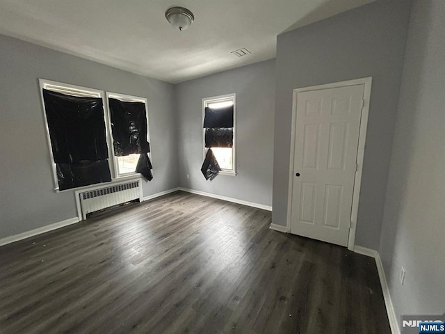 207 Tremont Ave, East Orange, NJ 07018 - unfurnished room featuring radiator, dark wood-type flooring, and baseboards