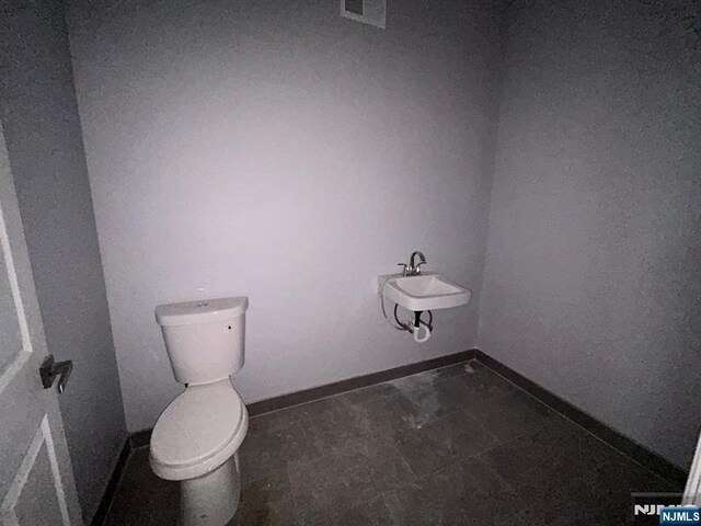 207 Tremont Ave, East Orange, NJ 07018 - bathroom with a sink, toilet, and baseboards