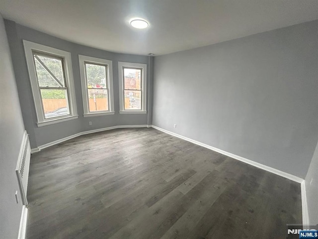 207 Tremont Ave, East Orange, NJ 07018 - spare room featuring dark wood finished floors and baseboards