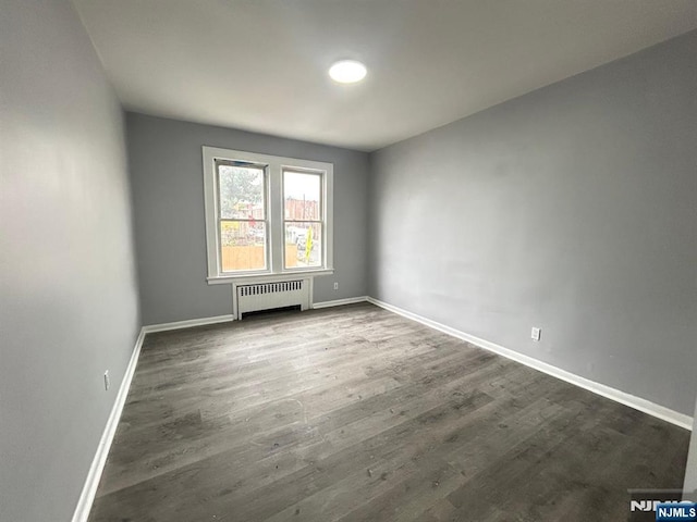 207 Tremont Ave, East Orange, NJ 07018 - spare room with radiator heating unit, baseboards, and wood finished floors