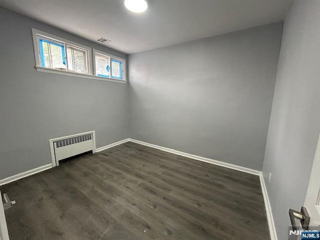 207 Tremont Ave, East Orange, NJ 07018 - empty room with radiator heating unit, baseboards, and dark wood-style floors