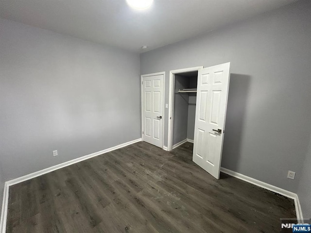 207 Tremont Ave, East Orange, NJ 07018 - unfurnished bedroom with dark wood-style flooring, baseboards, and a closet
