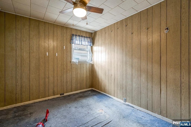 542 3rd Ave, Lyndhurst, NJ 07071 - empty room featuring ceiling fan, wood walls, and carpet flooring