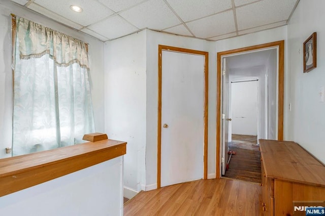 542 3rd Ave, Lyndhurst, NJ 07071 - corridor with wood finished floors, a drop ceiling, and baseboards