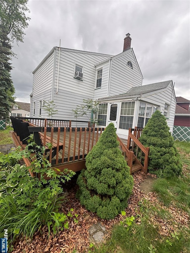 130 Riverview Ave, North Arlington, NJ 07031 - rear view of property with a chimney, a deck, and a sunroom