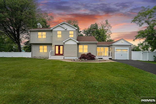 18 Breen Ter, Wayne, NJ 07470 - view of front facade featuring an attached garage, french doors, driveway, a chimney, and a gate