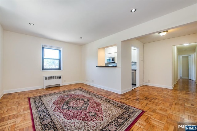 2333 Hudson Ter Unit A4, Fort Lee, NJ 07024 - empty room with radiator heating unit, baseboards, and recessed lighting