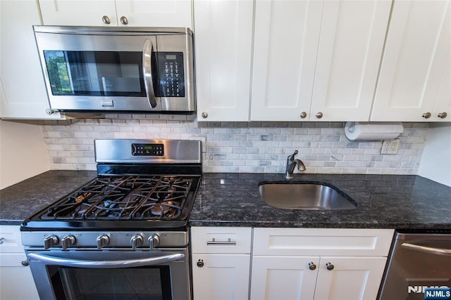 2333 Hudson Ter Unit A4, Fort Lee, NJ 07024 - kitchen featuring appliances with stainless steel finishes, a sink, white cabinets, and tasteful backsplash