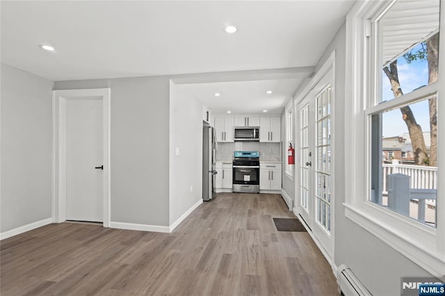 190 Washington Ave, Hackensack, NJ 07601 - kitchen with stainless steel appliances, light wood-type flooring, white cabinetry, decorative backsplash, and recessed lighting