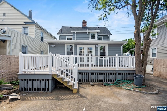 190 Washington Ave, Hackensack, NJ 07601 - rear view of house with a wooden deck, a chimney, stairs, and a shingled roof