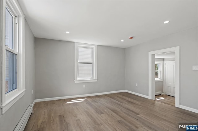 190 Washington Ave, Hackensack, NJ 07601 - empty room featuring a baseboard radiator, wood finished floors, baseboards, and recessed lighting