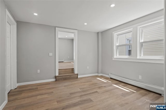 190 Washington Ave, Hackensack, NJ 07601 - unfurnished bedroom with a baseboard heating unit, light wood finished floors, baseboards, a baseboard radiator, and recessed lighting