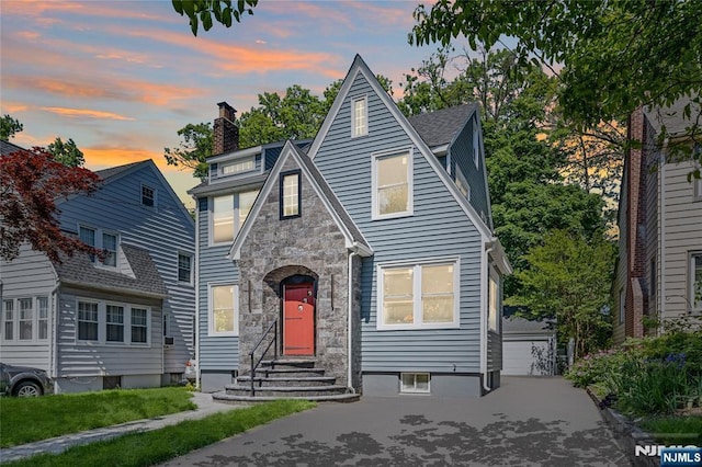 254 Springfield Ave, Rutherford, NJ 07070 - english style home with a chimney, stone siding, entry steps, an outdoor structure, and a garage