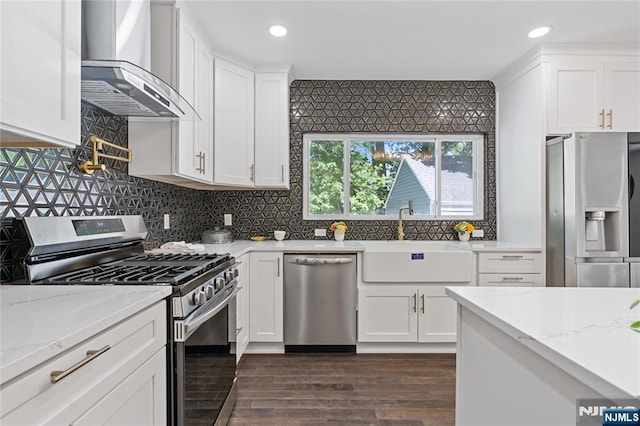 254 Springfield Ave, Rutherford, NJ 07070 - kitchen with appliances with stainless steel finishes, wall chimney exhaust hood, a sink, white cabinets, and recessed lighting