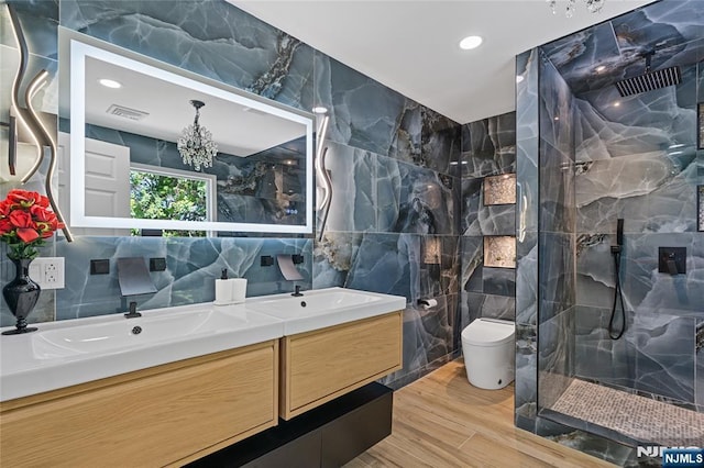254 Springfield Ave, Rutherford, NJ 07070 - bathroom with tile walls, double vanity, a marble finish shower, wood finished floors, and toilet
