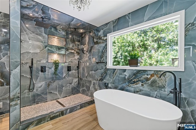 254 Springfield Ave, Rutherford, NJ 07070 - bathroom with tile walls, a soaking tub, wood tiled floors, a marble finish shower, and a chandelier