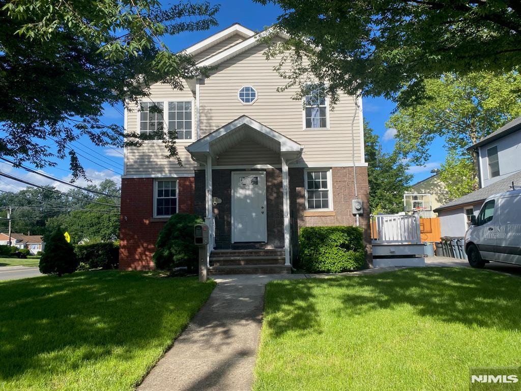 13-53 Sunnyside Dr, Fair Lawn, NJ 07410 - view of front facade featuring brick siding and a front yard