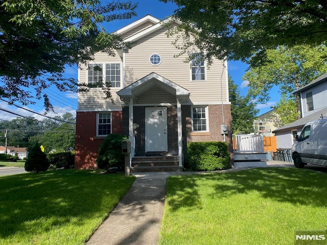 13-53 Sunnyside Dr, Fair Lawn, NJ 07410 - view of front facade featuring brick siding and a front yard